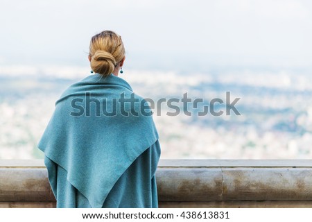 Back view of a woman with tied blond hair looking at the nature background during a nice sunny morning.
 Royalty-Free Stock Photo #438613831