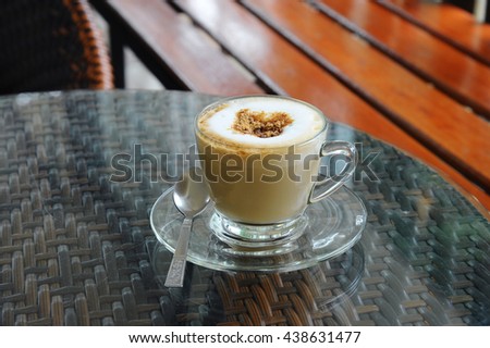 hot coffee cappuccino in cup on table (style still life)