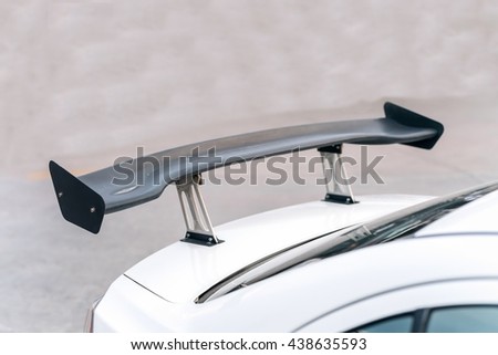car part ; Close up detail of a custom racing carbon fiber spoiler on the rear of a modern car Royalty-Free Stock Photo #438635593