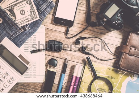 Set of travel accessory with budget calculating on wooden table background