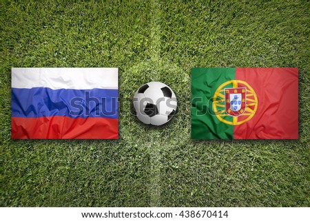 Russia vs. Portugal flags on green soccer field
