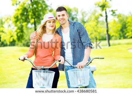 Happy smiling couple riding in the park.couple riding on bicycles in the park
