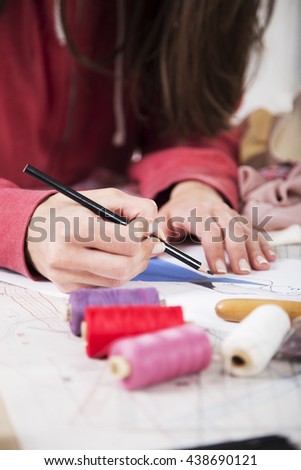 Fashion designer drawing in her fashion studio