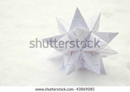 White paper star with snow as background.