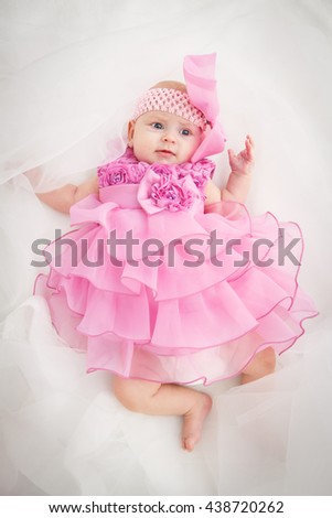 Portrait of a beautiful little baby girl in pink