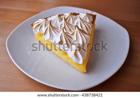 Lemon Tarts in plate white on wooden table.