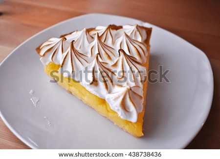 Lemon Tarts in plate white on wooden table.