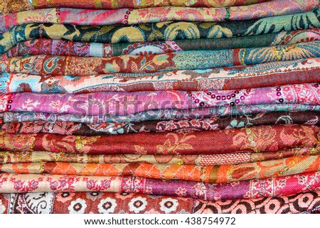 Colored Indian cashmere shawls are composed of a stack background