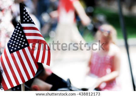 American flag show by people on 4th of july parade, god bless America, American flags attached background of a girl and peoples in a Fourth of July parade. Royalty-Free Stock Photo #438812173