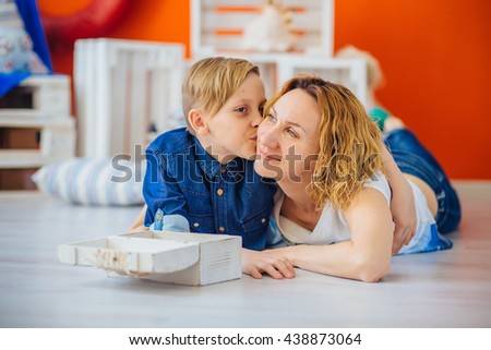 Son kissing happy mother