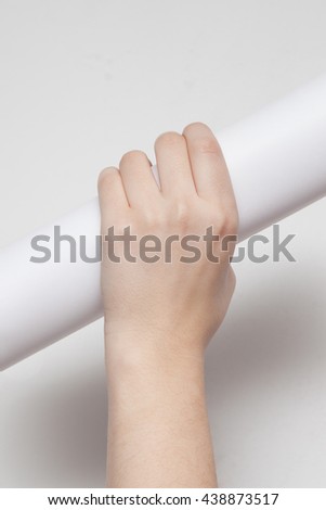 hand holding paper roll isolated on white