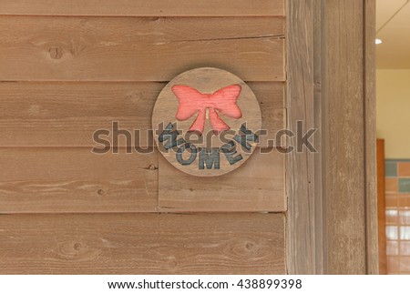 old Sign of public toilet for  lady  brown background