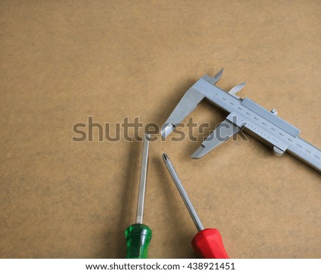 Various randomly arranged metal measuring tools;
various screwdriver