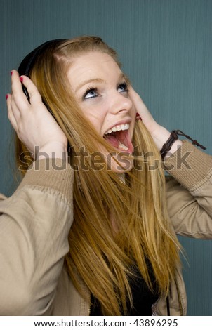 Beautiful Young Woman singing with headphones