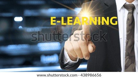 business hand pressing E LEARNING  text on blurred city background, business concept , business idea , strategy concept