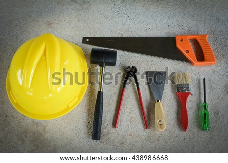 paint brush,Plastering trowel, hammer, screwdriver,Cream wire cutters, saw on the cement floor