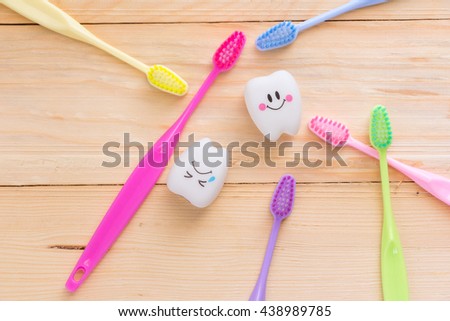 toothbrush and tooth on a wooden floor, concept dental