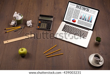 Computer laptop on wooden desk with office accessories 