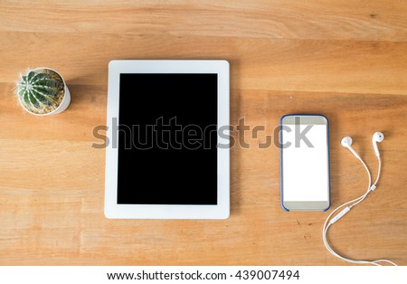 Smart phone with white blank empty screen on wooden table