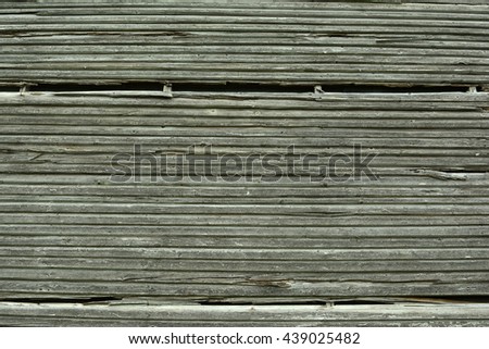 Old wooden board. Wooden wall with a shabby old paint. Fence. Wood texture. Cross section of the tree.