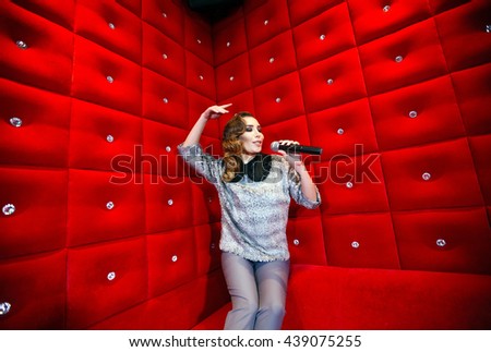 beautiful girl singing karaoke in a nightclub
