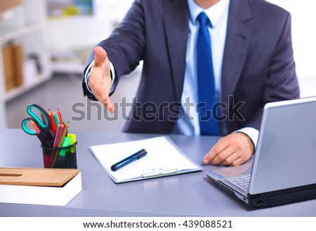 young businessman behind the desk in the Office