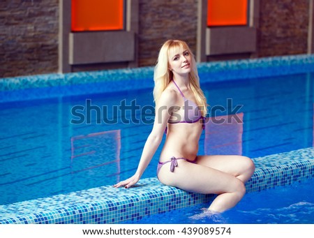 Girl sitting near the pool.