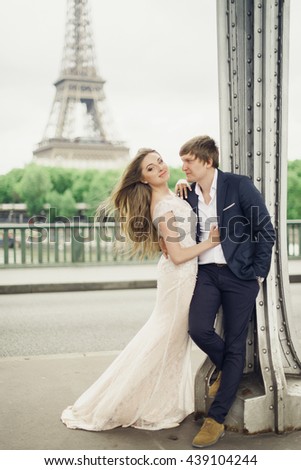 a young amazing people  standing against a background of the Eiffel Tower
