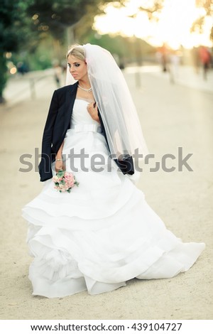 gorgeous girl in a wedding dress walking down the street