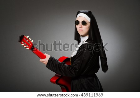 Funny nun with red guitar playing