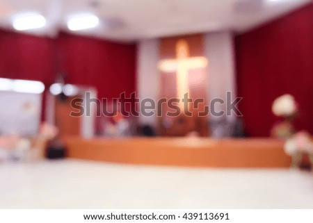 Blur image of cross in church .