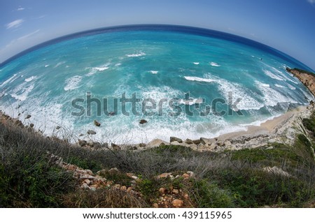 Fisheye photo of the Caribbean Sea, Beach at Dominican Republic, region Barahona, summer, curvy waves, blue water Royalty-Free Stock Photo #439115965