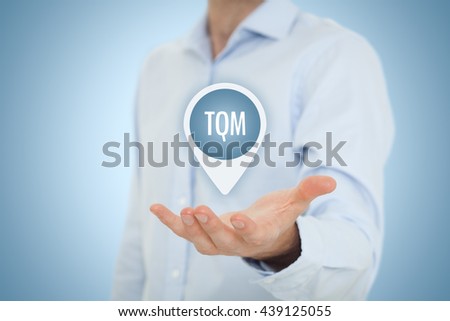 Total quality management concept. TQ manager hold target with text TQM.
 Royalty-Free Stock Photo #439125055