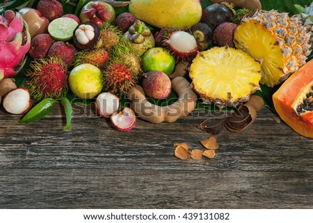 Fresh tropical fruit on wood on top
