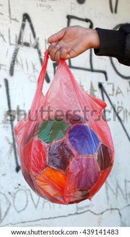  soccer ball , colorful, old , ragged in a nylon bag