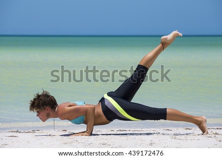 Woman practicing yoga at the beach, in a sunny day in the mexican Caribbean