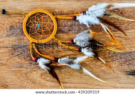 a Native american dream catcher on wooden background