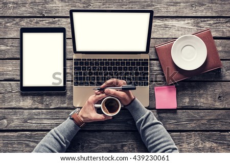 Top view of writer's workplace - laptop and tablet pc with cup of coffee. Clipping paths included. Royalty-Free Stock Photo #439230061