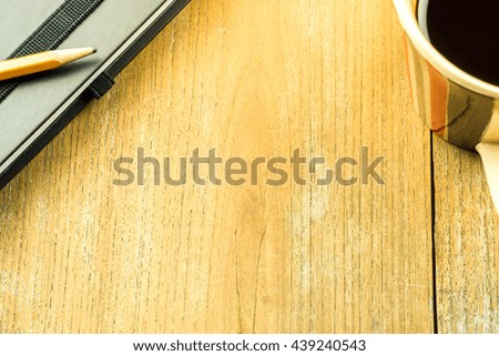 Overhead shot of laptop and notepad on a desk