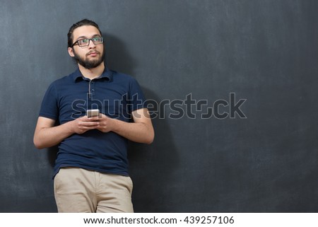 picture of young arab man on chalkboard using phone