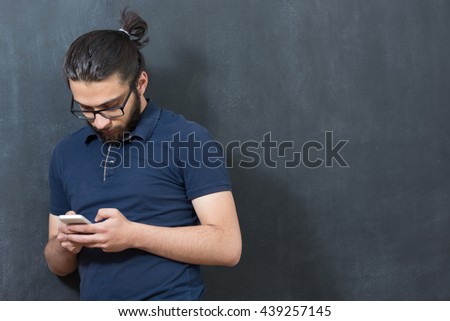 picture of young arab man on chalkboard using phone