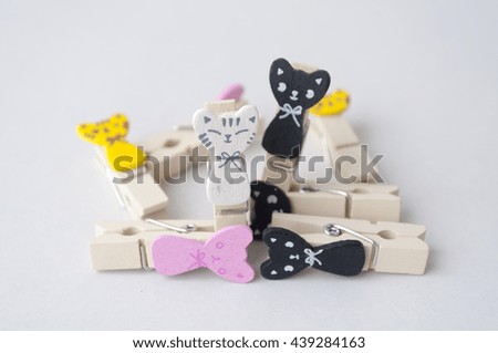 doll wooden cloth pegs on white background, selective focus