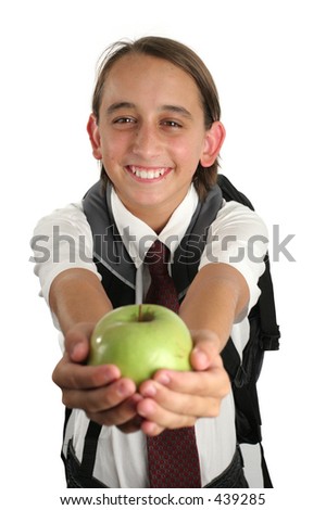 A boy presenting an apple to the teacher.
