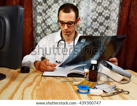 Medical doctor looking at x-ray picture of lungs in doctor's office