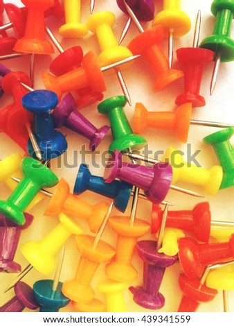 Coloured drawing pins with overlay