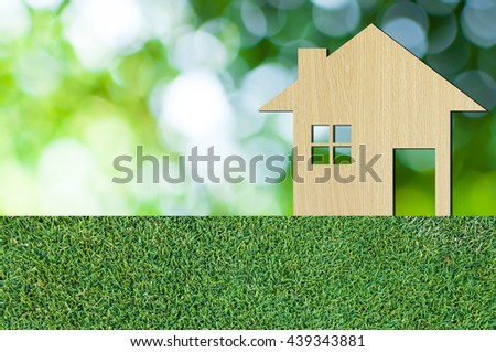 house icon from  wooden on grass texture nature background as symbol of mortgage,Dream house on nature background and space for your text