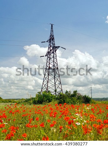 High voltage powerline transmission tower in field with poppies(power supply, ukrainian oblenergo sale)