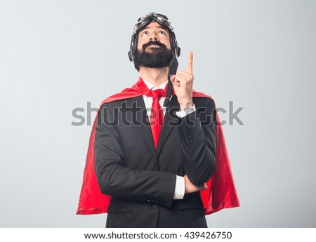 Super hero businessman  over grey background