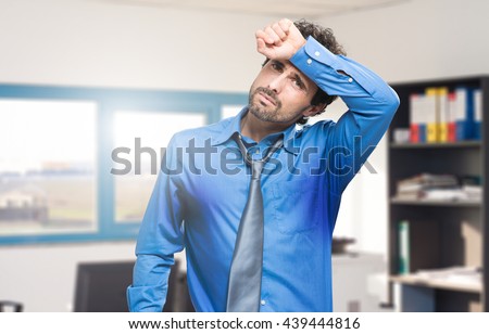  Sweating businessman due to hot climate Royalty-Free Stock Photo #439444816