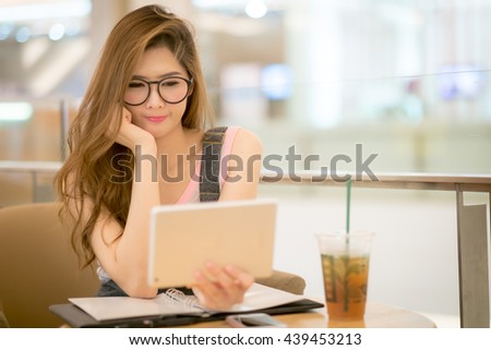 Woman  with laptop watching fun movie on tablet computer..